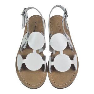 Top-down view of tan sandals with white circular cutout embellishments and ankle straps