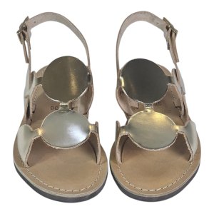Pair of beige open-toe sandals with shiny metallic discs on the upper straps, viewed from above.
