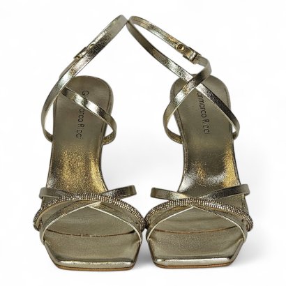 Gold metallic strappy sandals with square toes, photographed from above, showing crisscross straps and ankle buckles.