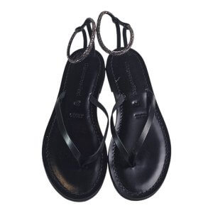 Top-down view of black leather sandals with thin straps and beaded ankle straps.