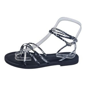 Sandal with black sole and clear, patterned straps crisscrossing over the foot
