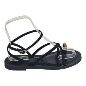 Flat open-toe sandal with black and clear crisscross straps and a black sole, close-up view